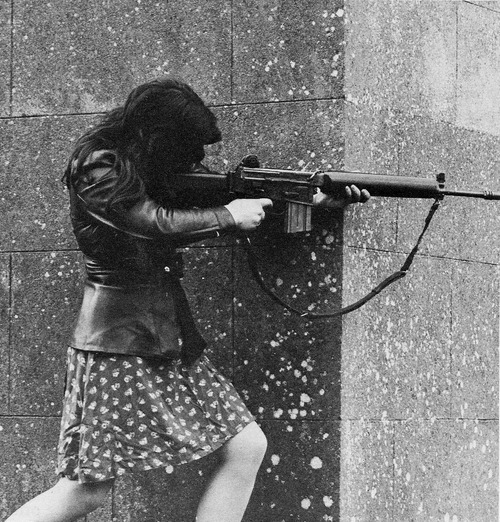 A female IRA fighter armed with an AR-18 taking aim at Pro-British troops during skirmishes. Cou.jpg